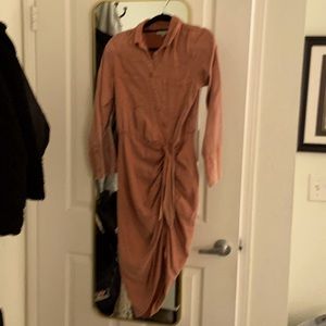 Soft denim dress with buttons on the front. Burt orange color figure hugging.